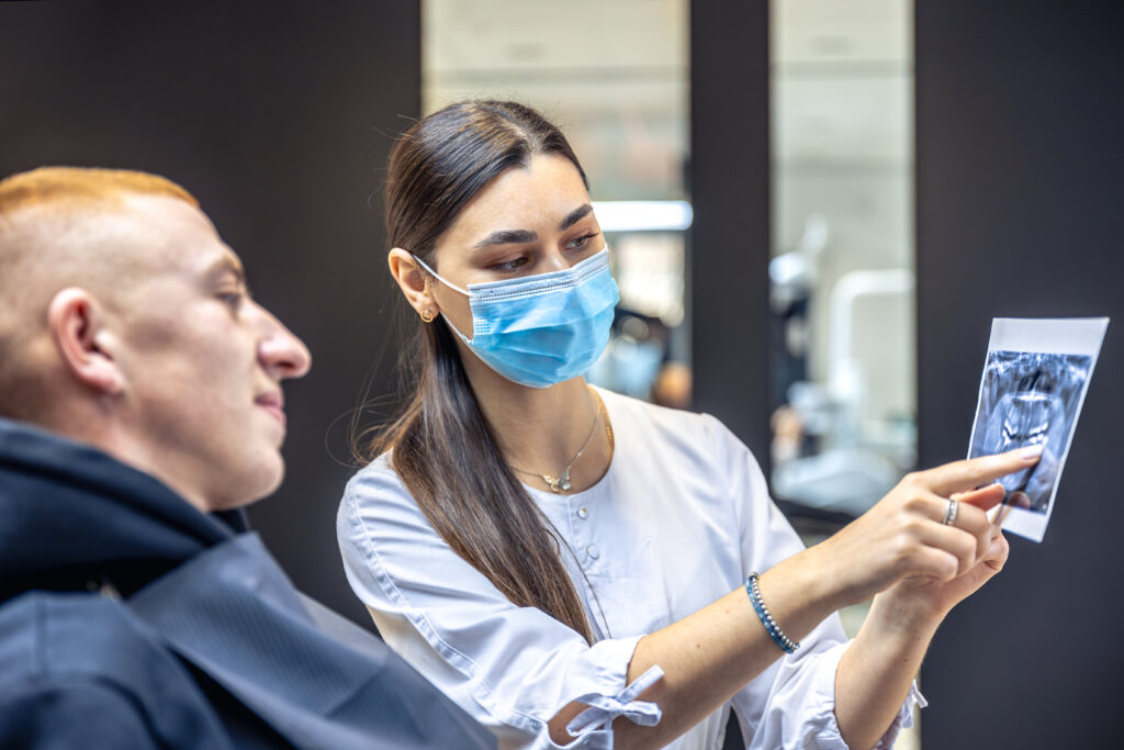 Patient reviewing important things to know before getting dental implants in Coimbatore.